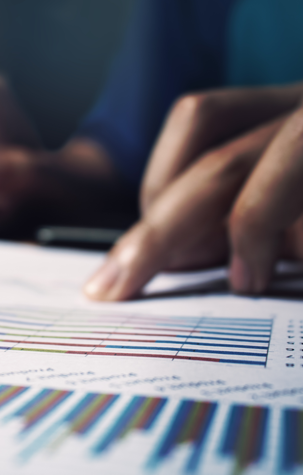 finger pointing at a data sheet as if analysing it