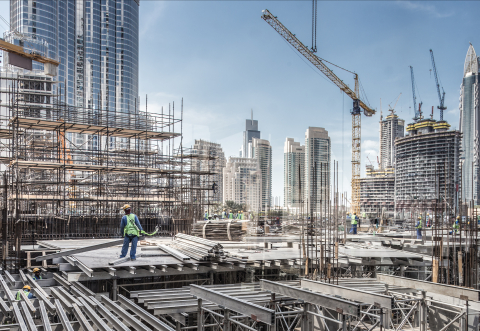 Laborers working on modern constraction site works. Fast urban development concept stock photo