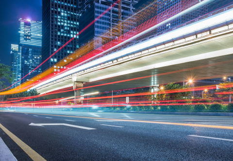 Colorful rays of light racing through the city