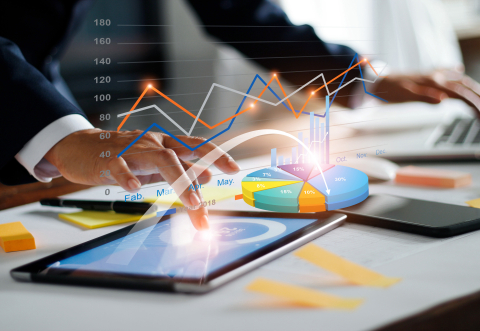 Picture of a man's index tracing on the screen of a tablet and illustrated with colorful virtual chart-like design