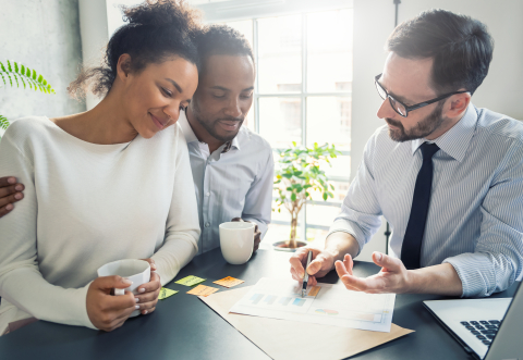 Young couple listening attentively to a financial advisor