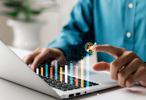 finger pointing at an upward virtual bar chart