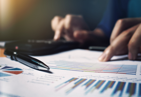 finger pointing at a data sheet as if analysing it